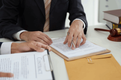 Business professionals examining contracts in a legal setting – Are New Texas MCA Regulations a Model for National Laws?