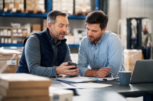 Two men discussing the referral program.