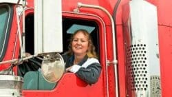 Female Truck Driver Smiling Out Her Window