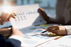 Reviewing charts to tackle small business financial challenges.