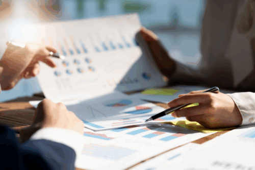 Reviewing charts to tackle small business financial challenges.